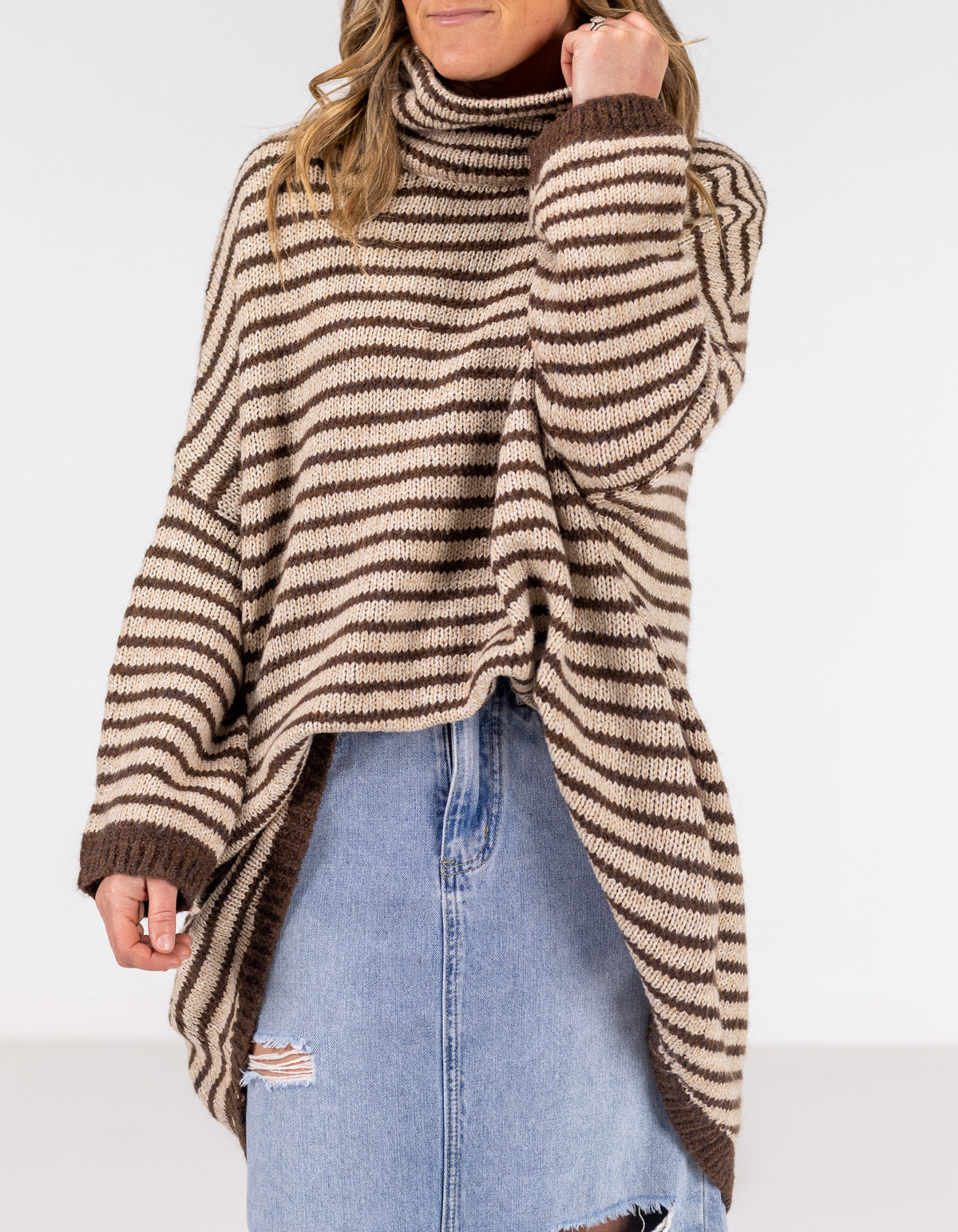 Close-up view of the funnel neck and soft brushed knit fabric on the chocolate and beige stripe jumper.