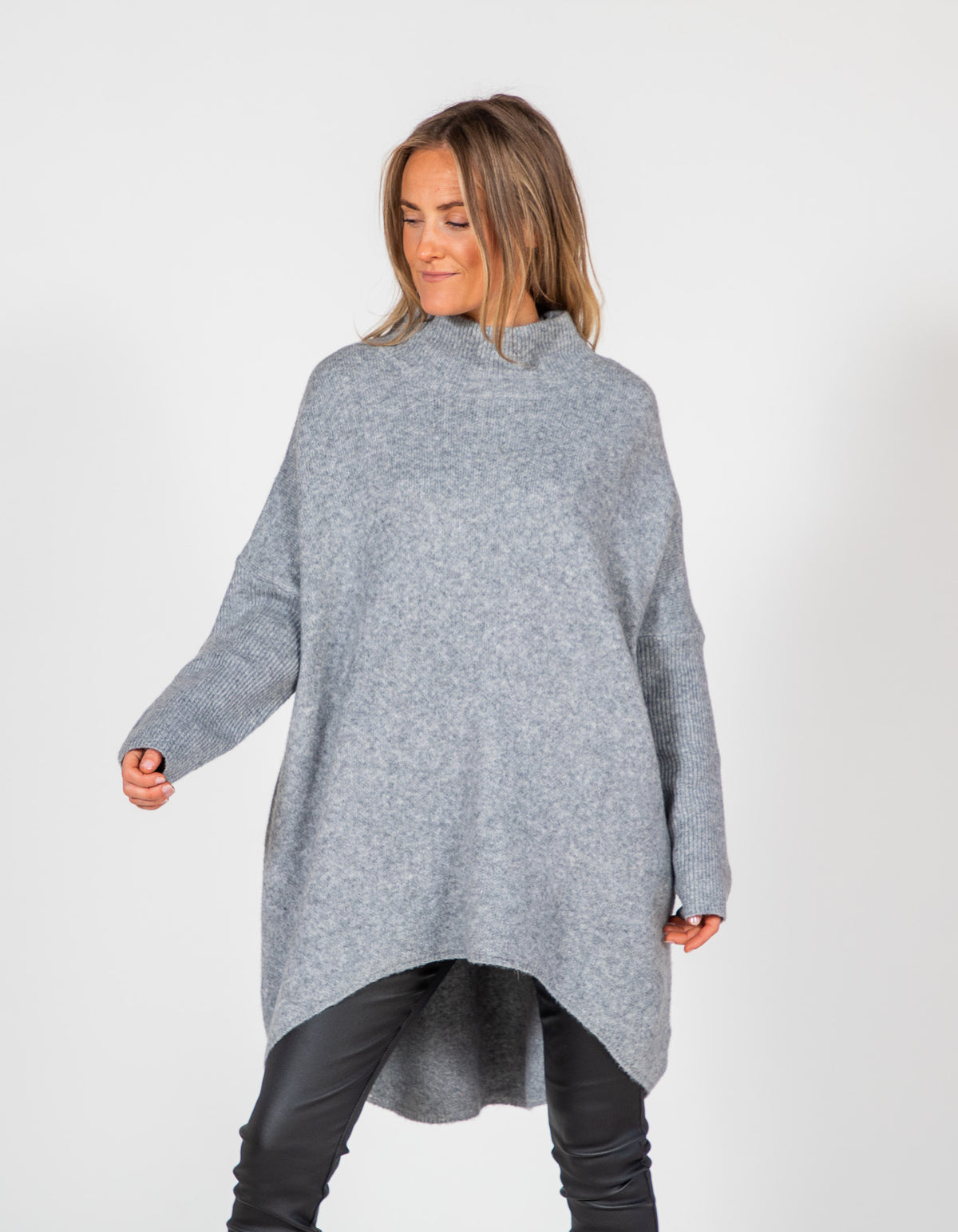 Oversized grey brushed knit jumper with a ribbed funnel neck, dropped shoulders, ribbed sleeves and a high-low hemline.