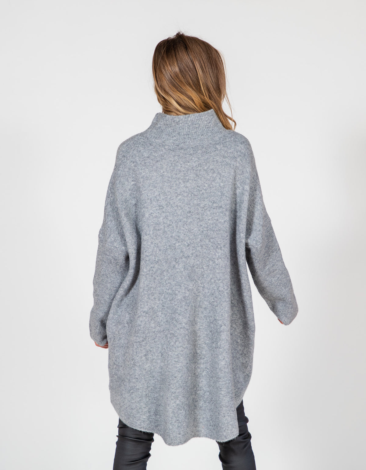 Back view of an oversized grey brushed knit jumper featuring drop shoulders, ribbed sleeves, and a long back hem.