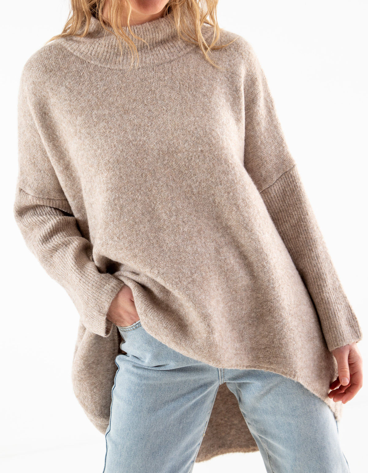 Front half-body shot of the Karma Kameleon beige knitwear displaying the loose drape and full-length ribbed sleeves.