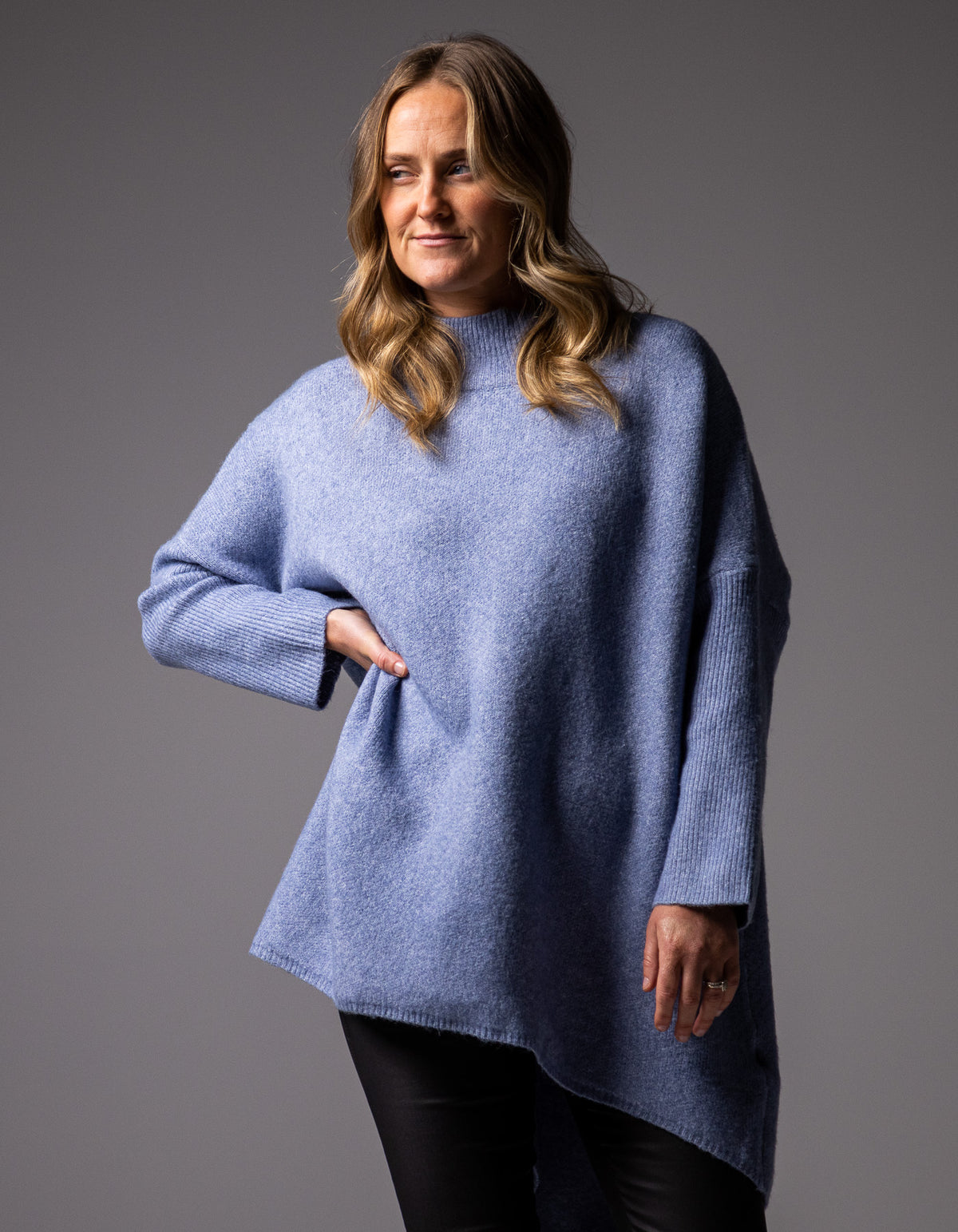 Front half-body shot of the blue oversized knit jumper showcasing the relaxed drop shoulders.